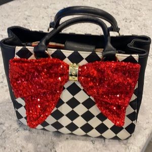 Betsey Johnson Black & White Harlequin Handbag with Red Sequin Bow feature.